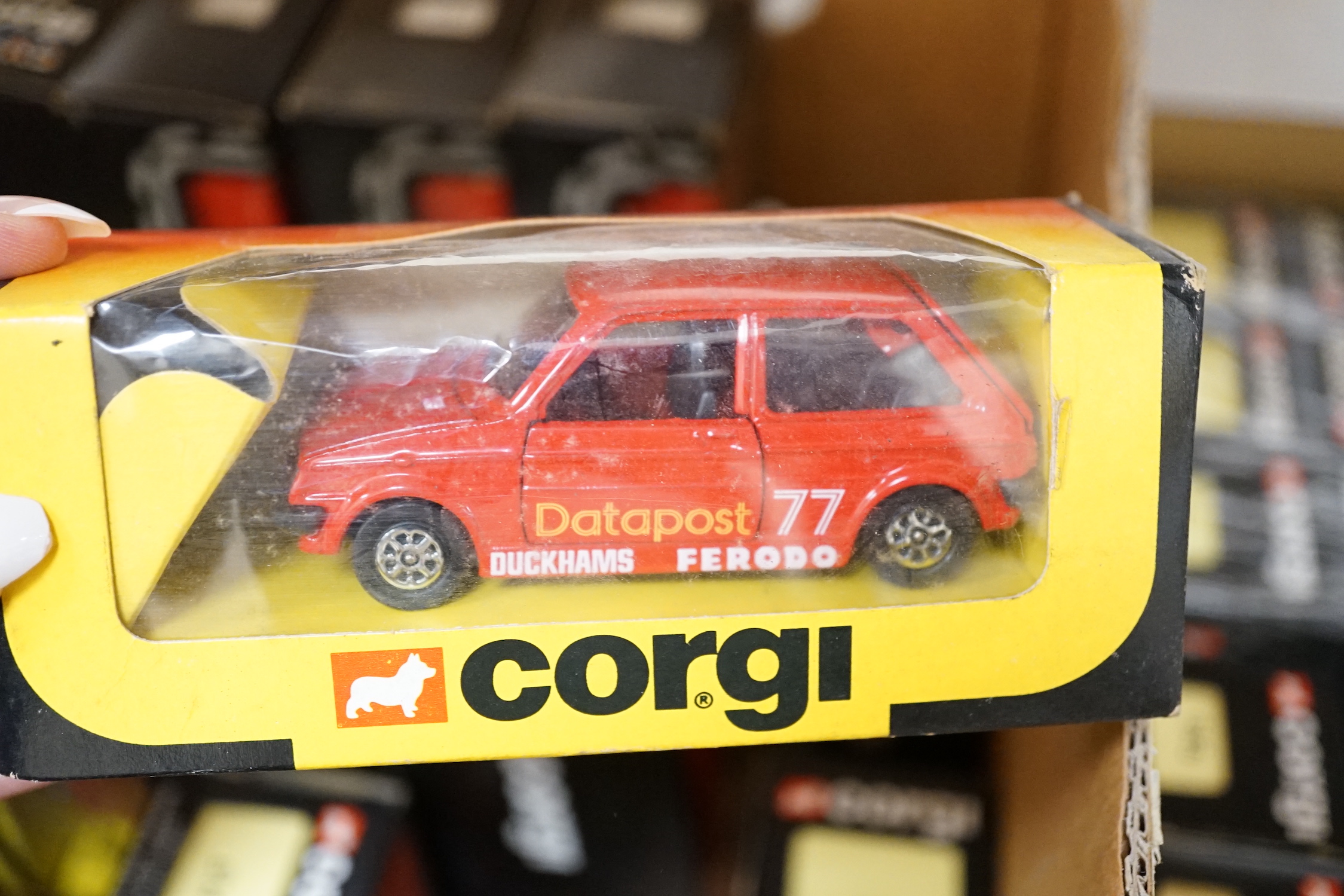 Sixty-six 1980's Corgi Toys Royal Mail vehicles, all boxed or packeted, together with an original ‘point of sale’ Post Office display cabinet for this series of vehicles containing unboxed display examples